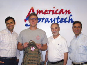 Sgt. Brett D'Allesandro, Backpacks for Life (2nd from left), is flanked by  Manav Lalwani, Bob Daria and Allen Lalwani of American Spraytech